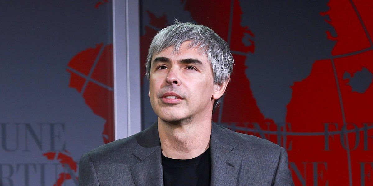 Gray-haired man, wearing a gray coat